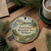 A round ornament with a scenic landscape of Fort Custer Recreation Area, Michigan, hanging on a wooden surface.