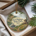 A decorative ornament with a scenic image of Fort Defiance State Park, Iowa, featuring a river, a castle, and a boat.