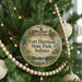 A round ornament on a Christmas tree, featuring a scenic image of Fort Harrison State Park, Indiana.