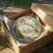 A decorative ornament in a wooden box, featuring a painting of Fort Massac State Park, Illinois.