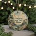 A round ornament with a scenic illustration of Fort Point State Park, Maine, hanging from a string.