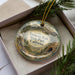A decorative ornament with a scenic landscape of mountains and forests, featuring the text "Fremont Peak State Park, California".