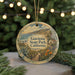 A round ornament with a scenic landscape of Gaviota State Park, California, featuring a beach, mountains, and a small building.