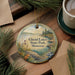 A decorative ornament with a scenic landscape of a lake surrounded by pine trees, featuring the text "Glacial Lakes State Park, Minnesota".