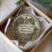 A decorative ornament in a box, featuring a scenic image of Gooseberry Falls State Park in Minnesota.