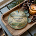 A decorative ornament with a serene beach scene and the text "Grayson Beach State Park, Florida" is displayed on a wooden tray, accompanied by pine cones and a lit candle.