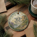 A circular ornament with a scenic landscape of a river, cliffs, and pine trees, along with the text "Great River Bluffs State Park, Minnesota".
