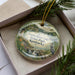 A decorative ornament featuring a scenic image of Green River Lake State Park in Kentucky, with a bird in the foreground and a natural landscape in the background.