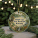 A circular ornament with a scenic image of a lake and a cabin, surrounded by greenery, with the text "Greenbo Lake State Resort Park, Kentucky" displayed prominently.