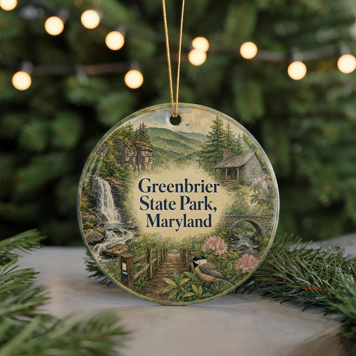 A round ornament with a scenic image of Greenbrier State Park, Maryland, featuring a waterfall, a bridge, and a bird.