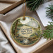 A decorative ornament with a scenic landscape of Greenwell State Park, Maryland, featuring a waterfall and pine trees.