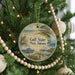 A round ornament hanging on a Christmas tree, featuring a scenic image of Gulf State Park, Alabama.