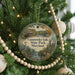 A round ornament hanging on a Christmas tree, featuring a scenic image of Gunpowder Falls State Park, Maryland.