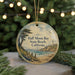 A round ornament with a scenic image of Half Moon Bay, California, featuring a lighthouse and a beach with a cliff.