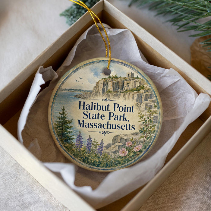 A circular ornament with a scenic illustration of Halibut Point State Park, Massachusetts, hanging from a string.