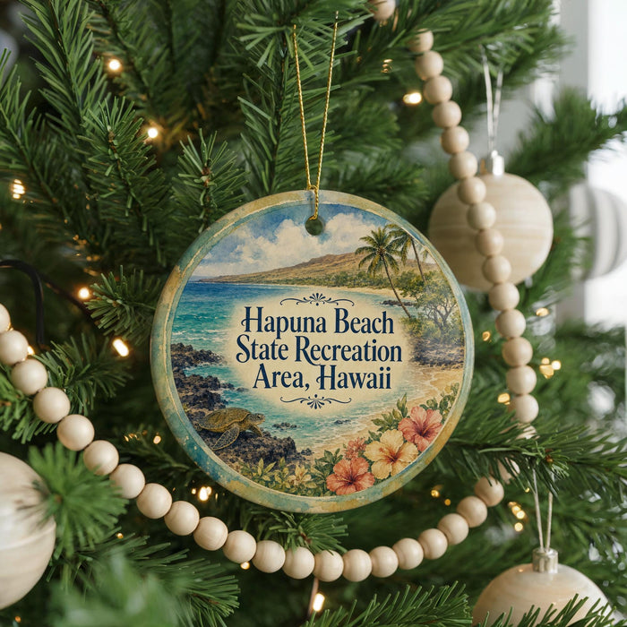 A circular ornament hanging on a Christmas tree, featuring a tropical beach scene with palm trees and a body of water.