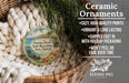 Ceramic ornaments, including a round ornament with a tropical beach scene, are displayed in a woven basket.