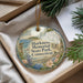 A decorative ornament with a scenic landscape of Harkness Memorial State Park, Connecticut, displayed in a box with pine branches.
