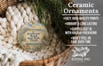 Ceramic ornaments, featuring a design of Henderson Beach State Park, Florida, hanging in a basket with pine branches.