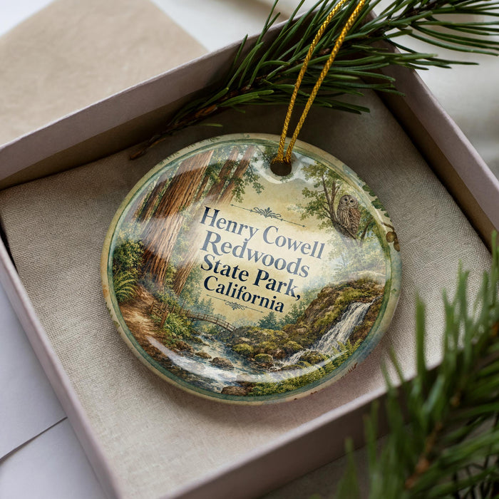 A decorative ornament in a box, featuring an illustration of Henry Cowell Redwoods State Park in California.