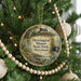 A round ornament hanging on a Christmas tree, featuring a scenic image of Herrington Manor State Park, Maryland.
