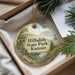 A decorative ornament with a scenic landscape of hills, trees, and a river, featuring the text "Hillsdale State Park, Kansas" on it.