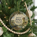 A round ornament hanging on a Christmas tree, featuring a scenic image of Historic Blakeley State Park, Alabama.