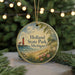 A round ornament with a lighthouse and a beach scene, featuring the text "Holland State Park, Michigan".