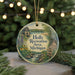 A round ornament with a scenic illustration of a lake, trees, and a bridge, surrounded by greenery and a sign that reads "Holly Recreation Area, Michigan".