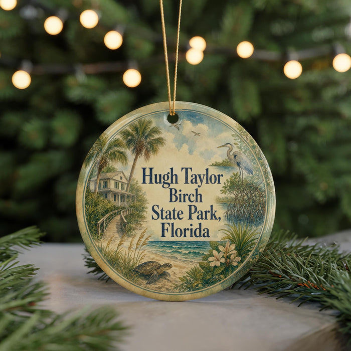A round ornament with a painting of a beach and palm trees, featuring the text "Hugh Taylor Birch State Park, Florida" on it.