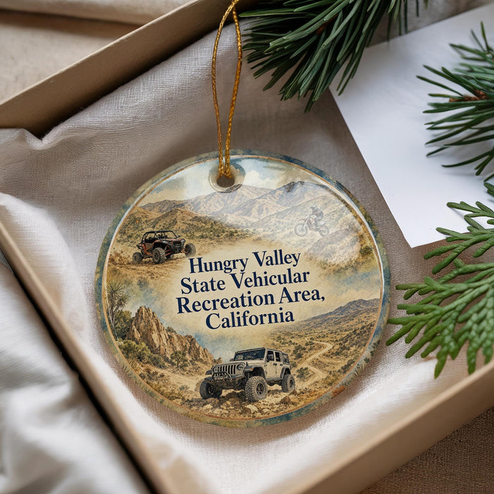 a round ornament with a desert landscape and two jeep-like vehicles, likely representing a jeep rally or off-road vehicle event.