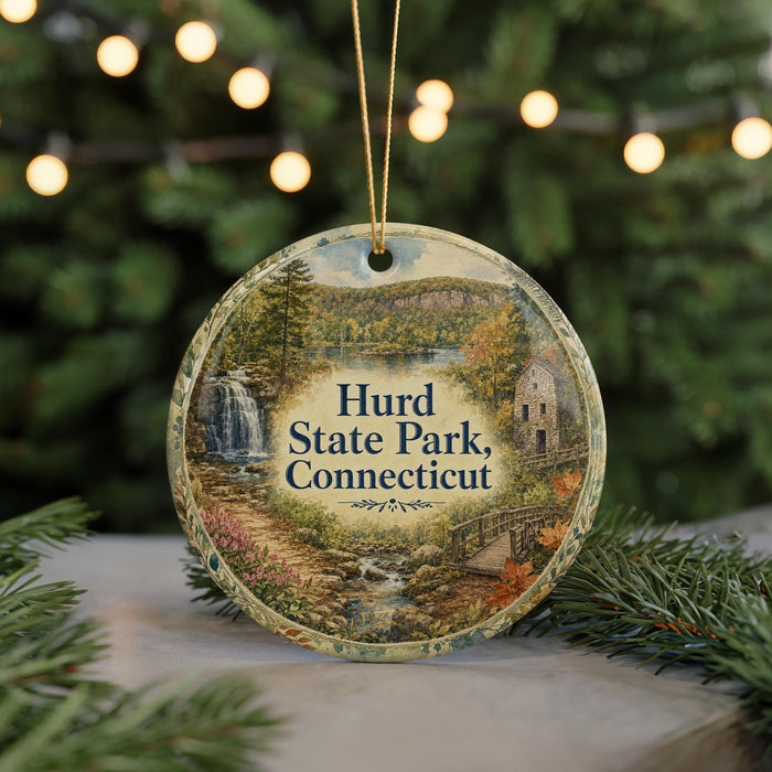 A round ornament with a scenic image of Hurd State Park, Connecticut, featuring a waterfall, a bridge, and a forest.
