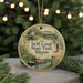 A circular ornament featuring an illustration of the I&M Canal State Trail in Illinois, with a bridge and a person riding a bicycle in the background.