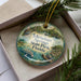 A decorative ornament featuring a scenic image of Ichetucknee Springs State Park, Florida, with a beaver and other wildlife in the foreground.