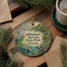 A decorative ornament featuring a scenic image of Ichetucknee Springs State Park, Florida, surrounded by pine branches and a cup of coffee.