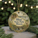 A round ornament with a scenic landscape of Illinois State Park, featuring a bridge, deer, and trees, is displayed against a blurred background of Christmas lights.