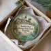 A decorative ornament in a box, featuring a tropical beach scene with palm trees, a bird, and a ship, along with the text "Indian Key Historic State Park, Florida".