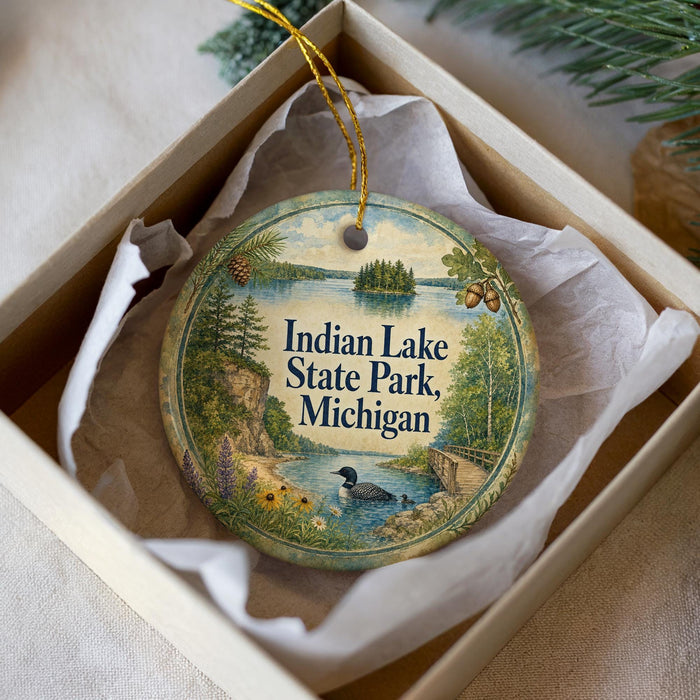 A decorative ornament in a box, featuring a scenic landscape with a lake, pine trees, and wildlife, including a duck.