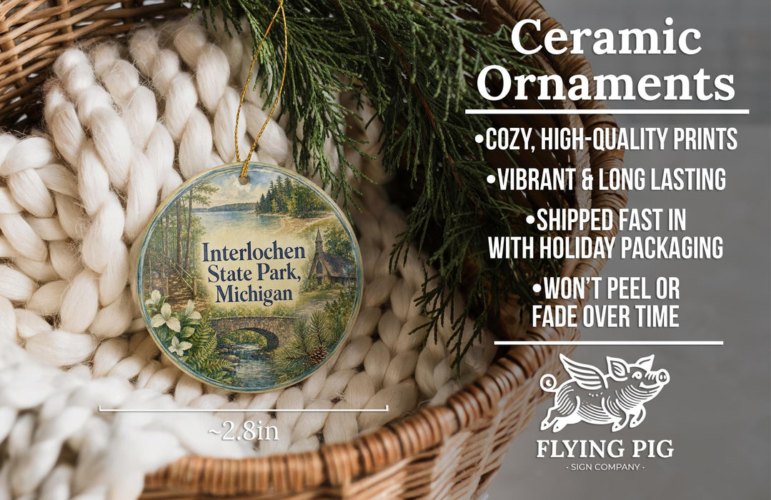Ceramic ornaments, featuring a scenic image of Interlochen State Park, Michigan, hanging from a wicker basket.
