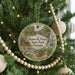 A round ornament hanging on a Christmas tree, featuring a scenic image of James H. Floyd State Park, Georgia.