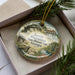 A decorative ornament featuring a scenic image of a historic plantation house surrounded by trees and greenery, with the text "Jarrell Plantation State Historic Site, Georgia" prominently displayed.