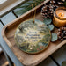 A decorative ornament featuring a rural scene with a house, tree, and pond, along with the text "Jarrell Plantation State Historic Site, Georgia".