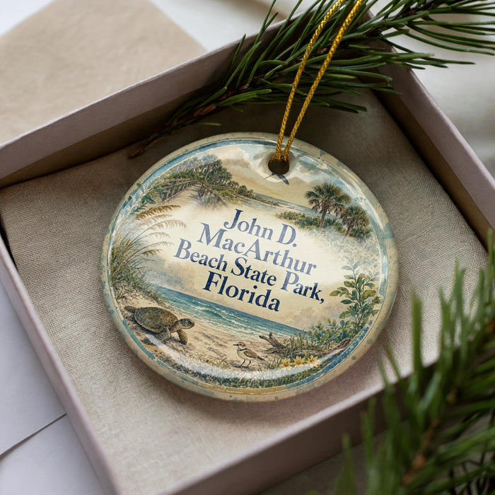 A decorative ornament in a box, featuring a beach scene with palm trees and a turtle.