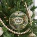 A round ornament hanging on a Christmas tree, featuring a scenic image of John Tanner State Park in Georgia.