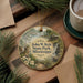 A circular ornament with a scenic image of John W. Kyle State Park, Mississippi, hanging on a wooden surface.