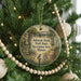 A round ornament hanging on a Christmas tree, featuring a scenic image of a trail in the Johnson-Sauk Trail State Recreation Area, Illinois.
