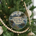 A circular ornament hanging on a Christmas tree, featuring a scenic image of Kachemak Bay State Park, Alaska.