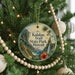 A circular ornament hanging on a Christmas tree, featuring a scenic image of the Kalalau Trail State Park in Hawaii.