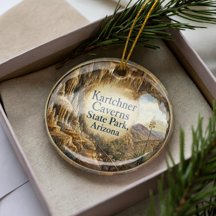 A decorative ornament in a box, featuring an image of the Karchner Caves in Arizona.
