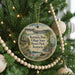 A round ornament hanging on a Christmas tree, featuring a scenic view of Kentucky Village State Resort Park.